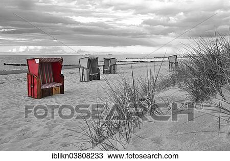 Stock Image - "Roofed wicker beach chairs on the beach, colour key, Warnemunde, Mecklenburg-Vorpommern, Germany, Europe". Fotosearch