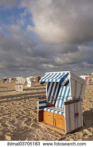Stock Image - "Roofed wicker beach chairs on the beach, St. Peter-Ording, Eiderstedt, North Frisia, Schleswig-Holstein, Germany, Europe". Fotosearch