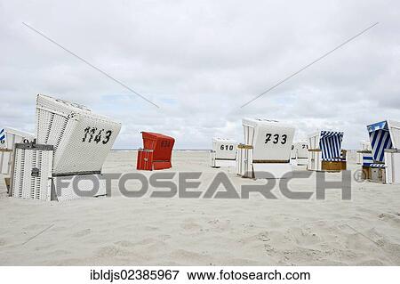 Stock Photo - "Roofed wicker beach chairs on the beach of St. Peter-Ording, North Frisia, Schleswig-Holstein, Germany, Europe". Fotosearch