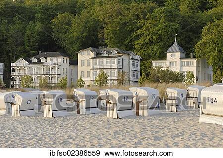 "Roofed wicker beach chairs on the beach of the Baltic Sea resort town of Binz, with resort architecture or Baeder architecture at the rear, Ruegen, Mecklenburg-Western Pomerania, Germany, Europe" View Large Photo Image Stock Photo - "Roofed wicker beach chairs on the beach of the Baltic Sea resort town of Binz, with resort architecture or Baeder architecture at the rear, Ruegen, Mecklenburg-Western Pomerania, Germany, Europe". Fotosearch