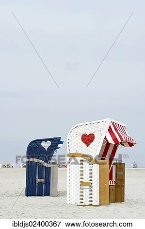 "Roofed wicker beach chairs with hearts on the beach at Norddorf, Amrum, North Frisian Islands, Schleswig-Holstein, Germany, Europe" View Large Photo Image Stock Photo - "Roofed wicker beach chairs with hearts on the beach at Norddorf, Amrum, North Frisian Islands, Schleswig-Holstein, Germany, Europe". Fotosearch