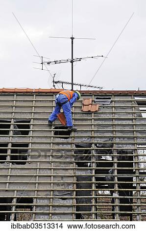 Picture - "Roofers untiling roof framework, demolition of a house, North Rhine-Westphalia, Germany, Europe". Fotosearch