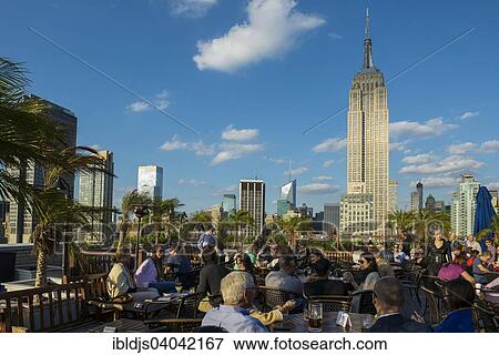 Stock Photo - "Rooftop bar and Empire State Building, 5th Avenue, Manhattan, New York, United States, North America". Fotosearch