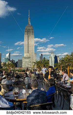 "Rooftop bar and Empire State Building, 5th Avenue, Manhattan, New York, United States, North America" View Large Photo Image Stock Photography - "Rooftop bar and Empire State Building, 5th Avenue, Manhattan, New York, United States, North America". Fotosearch