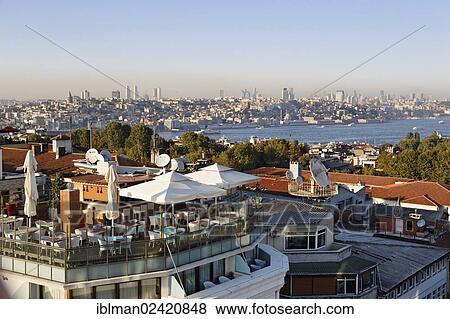 Stock Photo - Rooftop terrace of Arden City Hotel in Old City Sultanahmet, Golden Horn, Beyoglu and Beiktas at the rear, Istanbul, Turkey, Europe, Asia. Fotosearch
