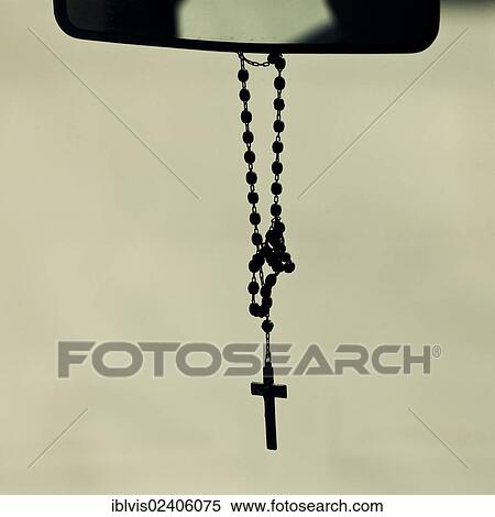Rosary hanging from mirror in a car View Large Photo Image Stock Photography - Rosary hanging from mirror in a car. Fotosearch