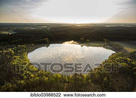 "Roter See Lake with fog, morning atmosphere sunrise, Roggentin, Mecklenburg Lake District, Mecklenburg-Western Pomerania, Germany, Europe" View Large Photo Image Stock Image - "Roter See Lake with fog, morning atmosphere sunrise, Roggentin, Mecklenburg Lake District, Mecklenburg-Western Pomerania, Germany, Europe". Fotosearch
