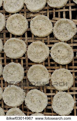Stock Photo - "Round rice cakes made of glutinous rice drying on a bamboo frame, Luang Prabang, Luang Prabang, Luang Prabang Province, Laos, Asia". Fotosearch