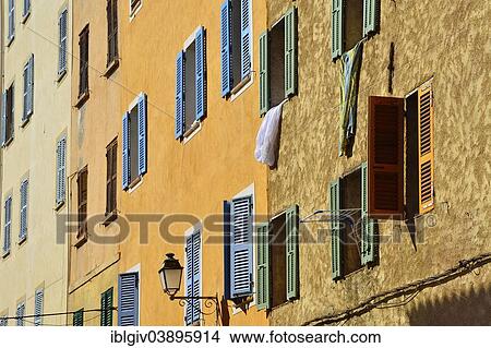 "Row of houses with colourful shutters, L'Ile Rousse, Balagne, Corsica, France, Europe" View Large Photo Image Picture - "Row of houses with colourful shutters, L'Ile Rousse, Balagne, Corsica, France, Europe". Fotosearch