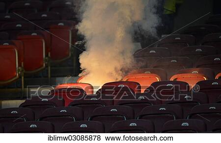 Stock Photo - "Row of seats going up in flames, flares, fireworks on the seats, fire, Mercedes-Benz Arena, Stuttgart, Baden-Wurttemberg, Germany, Europe". Fotosearch