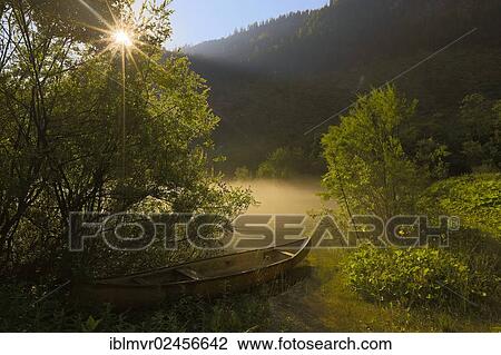 "Rowing boat in the morning mist with sunrays, Gosau, Salzkammergut, Austria, Europe" View Large Photo Image Stock Image - "Rowing boat in the morning mist with sunrays, Gosau, Salzkammergut, Austria, Europe". Fotosearch