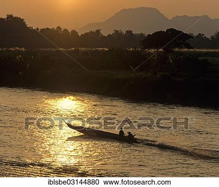 "Ruea Hang Yao or long tail boat, speedboat on the Kok River, at sunset, Chiang Rai, Chiang Rai Province, Northern Thailand, Thailand, Asia" View Large Photo Image Stock Image - "Ruea Hang Yao or long tail boat, speedboat on the Kok River, at sunset, Chiang Rai, Chiang Rai Province, Northern Thailand, Thailand, Asia". Fotosearch
