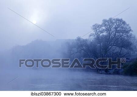 Stock Image - "Ruhr valley with the Ruhr river, early morning fog in autumn, Wetter, Ruhr Area, North Rhine-Westphalia, Germany, Europe". Fotosearch