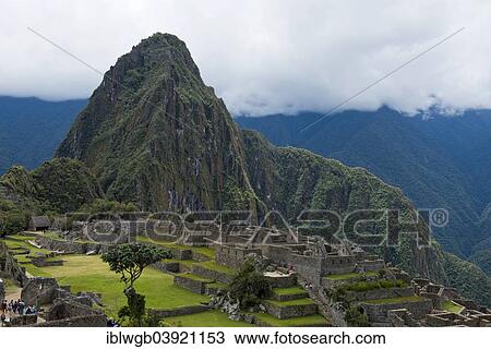 Stock Image - "Ruins in front of the mountain Huayna Picchu, the Inca city of Machu Picchu with the main square or Plaza Principal and terraces, UNESCO World Heritage Site, Urubamba Valley, near Cusco, Andes, Peru, South America". Fotosearch
