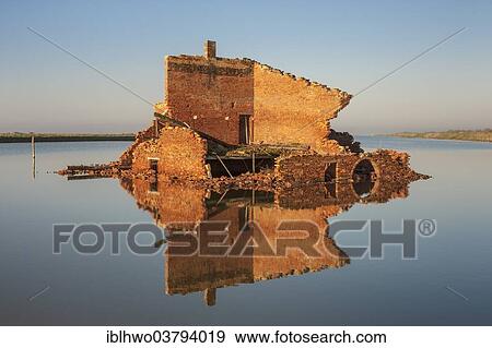 "Ruins off a red brick building in a lagoon, with reflections, Po River Delta, Comacchio, Emilia-Romagna, Italy, Europe" View Large Photo Image Stock Photo - "Ruins off a red brick building in a lagoon, with reflections, Po River Delta, Comacchio, Emilia-Romagna, Italy, Europe". Fotosearch