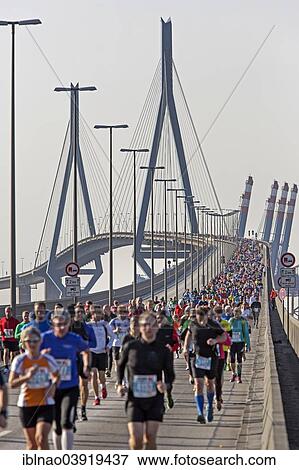 Stock Photo - "Runners at the Kohlbrandbruckenlauf 2013 race, Hamburg, Germany, Europe". Fotosearch