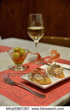 "Russian salad with Iberico ham on white bread, green olives and white wine in a tapas bar, Palma, Mallorca, Balearic Islands, Spain, Europe" View Large Photo Image Stock Photo - "Russian salad with Iberico ham on white bread, green olives and white wine in a tapas bar, Palma, Mallorca, Balearic Islands, Spain, Europe". Fotosearch