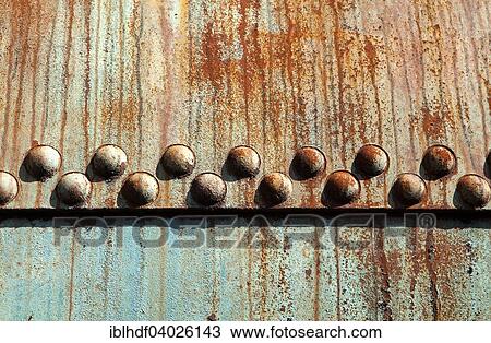 Stock Image - Rusted metal construction with rivets. Fotosearch