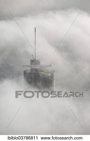 Stock Image - "RWE Tower amidst the clouds, aerial view, Essen, Ruhr area, North Rhine-Westphalia, Germany, Europe". Fotosearch
