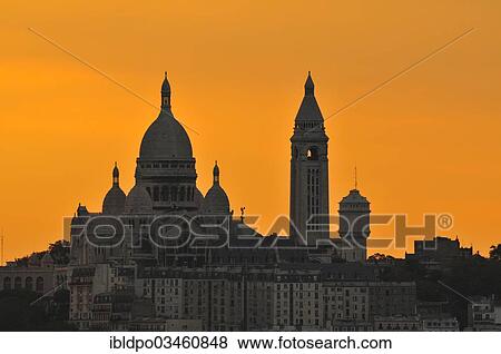 Stock Photo - "Sacre-Coeur Basilica, Basilique du Sacre Coeur against an orange sky at dusk, Paris, Ile-de-France, France, Europe". Fotosearch