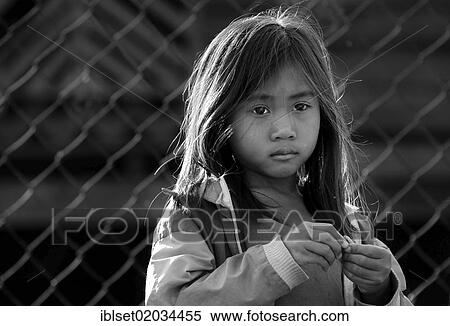 "Sad girl in front of fence in Laos, Southeast Asia, Asia" View Large Photo Image Stock Photography - "Sad girl in front of fence in Laos, Southeast Asia, Asia". Fotosearch