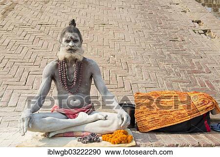 "Sadhu, holy man or wandering ascetic sitting in the lotus position on a cloth, his body is smeared with white ashes in the sign of Shiva, Varanasi, Uttar Pradesh, India, Asia" View Large Photo Image Stock Image - "Sadhu, holy man or wandering ascetic sitting in the lotus position on a cloth, his body is smeared with white ashes in the sign of Shiva, Varanasi, Uttar Pradesh, India, Asia". Fotosearch