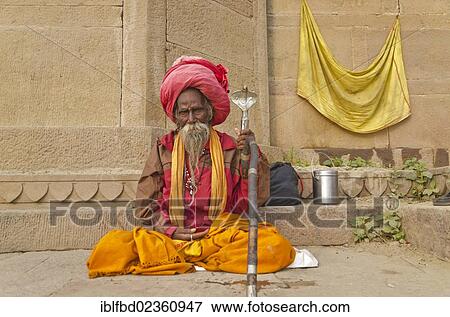 "Sadhu, holy man, sitting at one of the ghats of the historic city of Varanasi, India, Asia" View Large Photo Image Stock Photo - "Sadhu, holy man, sitting at one of the ghats of the historic city of Varanasi, India, Asia". Fotosearch