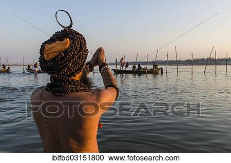 "Sadhu, holy man, taking a bath and praying in the Sangam, the confluence of the rivers Ganges, Yamuna and Saraswati, just before sunset, Kumbha Mela mass Hindu pilgrimage, Allahabad, Uttar Pradesh, India, Asia" View Large Photo Image Stock Image - "Sadhu, holy man, taking a bath and praying in the Sangam, the confluence of the rivers Ganges, Yamuna and Saraswati, just before sunset, Kumbha Mela mass Hindu pilgrimage, Allahabad, Uttar Pradesh, India, Asia". Fotosearch