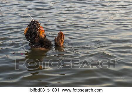 "Sadhu, holy man, taking a bath and praying in the Sangam, the confluence of the rivers Ganges, Yamuna and Saraswati, just before sunset, Kumbha Mela mass Hindu pilgrimage, Allahabad, Uttar Pradesh, India, Asia" View Large Photo Image Stock Image - "Sadhu, holy man, taking a bath and praying in the Sangam, the confluence of the rivers Ganges, Yamuna and Saraswati, just before sunset, Kumbha Mela mass Hindu pilgrimage, Allahabad, Uttar Pradesh, India, Asia". Fotosearch