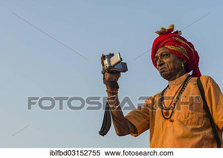 "Sadhu, holy man, taking pictures at Shahi Snan, the royal bath, during Kumbha Mela festival, Allahabad, Uttar Pradesh, India, Asia" View Large Photo Image Stock Photography - "Sadhu, holy man, taking pictures at Shahi Snan, the royal bath, during Kumbha Mela festival, Allahabad, Uttar Pradesh, India, Asia". Fotosearch