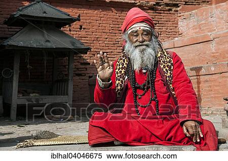 Stock Photography - "Sadhu, painted face, red clothes, Kathmandu, Nepal, Asia". Fotosearch