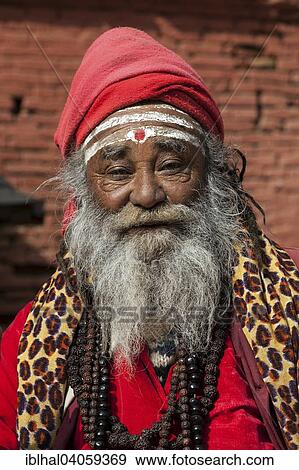Stock Photo - "Sadhu, red turban and clothing, portrait, Kathmandu, Nepal, Asia". Fotosearch