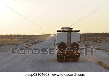 Stock Photo - "Safari truck on a gravel track, Etosha National Park, Okaukuejo, Kunene Region, Namibia, Africa". Fotosearch