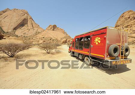 Safari truck, savannah landscape with granite rocks and Spitzkoppe Mountain, Grosse Spitzkuppe Nature Reserve, Namibia, Africa View Large Photo Image Stock Image - Safari truck, savannah landscape with granite rocks and Spitzkoppe Mountain, Grosse Spitzkuppe Nature Reserve, Namibia, Africa. Fotosearch