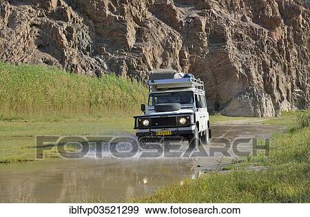"Safari vehicle in the Hoarusib river valley, Purros, Kaokoland, Kunene, Namibia, Africa" View Large Photo Image Stock Photo - "Safari vehicle in the Hoarusib river valley, Purros, Kaokoland, Kunene, Namibia, Africa". Fotosearch