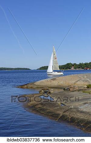 Stock Photograph - "Sailboat and typical round polished rocks, roches moutonnees, on Finnhamn Island in the Stockholm Middle Archipelago, Stockholm, Sweden, Europe". Fotosearch