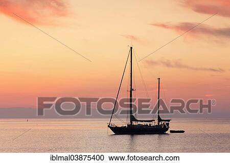"Sailboat at sunset, near Port de Centuri, Corsica, France, Europe" View Large Photo Image Stock Image - "Sailboat at sunset, near Port de Centuri, Corsica, France, Europe". Fotosearch