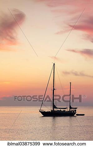 "Sailboat at sunset, near Port de Centuri, Corsica, France, Europe" View Large Photo Image Stock Photo - "Sailboat at sunset, near Port de Centuri, Corsica, France, Europe". Fotosearch