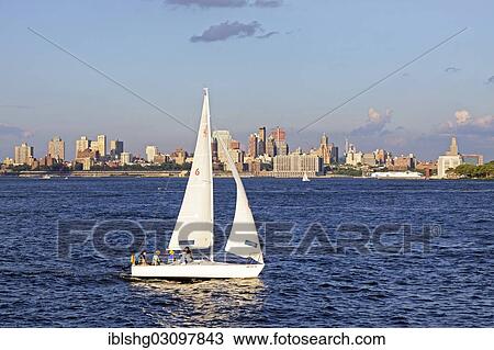 Stock Image - "Sailboat in front of the Brooklyn skyline, Manhattan, New York City, New York, United States, North America". Fotosearch