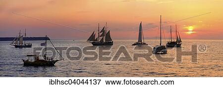 Stock Photo - "Sailboats, sunset, panorama view, Oia, Santorini, Cyclades, Aegean Sea, Greece, Europe". Fotosearch