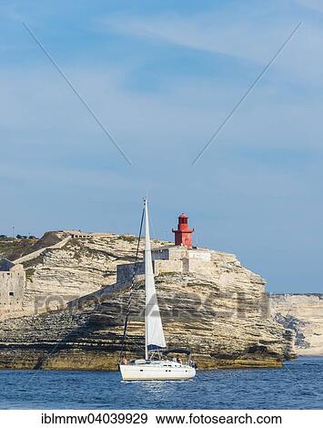 "Sailing boat off the chalk cliffs and the lighthouse of Bonifacio, Corsica, France, Europe" View Large Photo Image Stock Photo - "Sailing boat off the chalk cliffs and the lighthouse of Bonifacio, Corsica, France, Europe". Fotosearch
