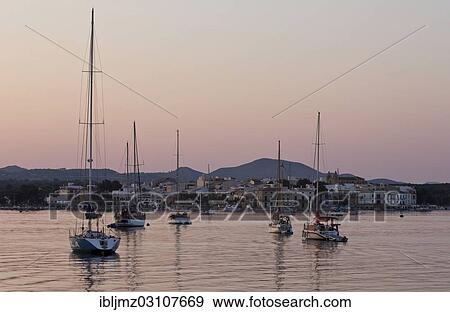 "Sailing boats in a harbour at sunset, Portocolom, Mallorca, Majorca, Balearic Islands, Spain, Europe" View Large Photo Image Stock Photo - "Sailing boats in a harbour at sunset, Portocolom, Mallorca, Majorca, Balearic Islands, Spain, Europe". Fotosearch