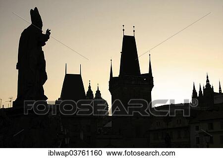 Stock Image - "Saint figure and Lesser Town Bridge Tower, Prague, Czech Republic, Europe". Fotosearch