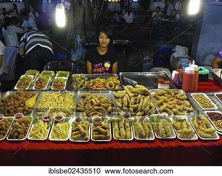 "Salesgirl at a night market, breaded fish, Chiang Rai, Northern Thailand, Thailand, Asia" View Large Photo Image Stock Image - "Salesgirl at a night market, breaded fish, Chiang Rai, Northern Thailand, Thailand, Asia". Fotosearch