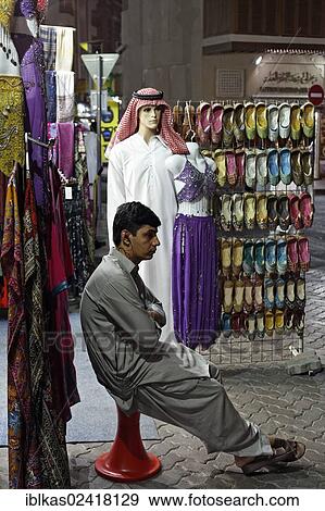 Salesman sitting bored in front of his shop, Deira Old Souk, United Arab Emirates, Middle East, Asia View Large Photo Image Stock Photo - Salesman sitting bored in front of his shop, Deira Old Souk, United Arab Emirates, Middle East, Asia. Fotosearch