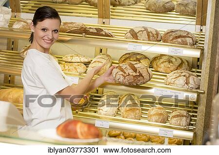 "Saleswoman in a bakery standing in front of the bread shelf, Austria, Europe" View Large Photo Image Stock Image - "Saleswoman in a bakery standing in front of the bread shelf, Austria, Europe". Fotosearch