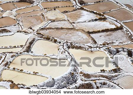 Picture - "Salinas de Maras, salt pans on a mountainside, built by the Incas and still in operation today, Pichingote, Cusco region, Andes, Peru, South America". Fotosearch