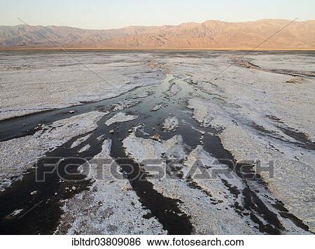Stock Photograph - "Salt marshes in the morning, Panamint Range in the back, central Death Valley, Death Valley National Park, California, USA". Fotosearch