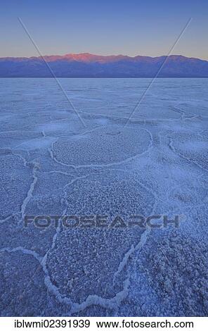 Stock Photo - "Salt pan, salt crystals, before sunrise at Badwater Basin, Panamint Range, Death Valley National Park, Mojave Desert, California, USA". Fotosearch