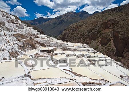 Stock Image - "Salt pans on a mountainside, Salinas de Maras salt pans, created by the Incas and still in operation, Pichingote, Cusco region, Andes, Peru, South America". Fotosearch